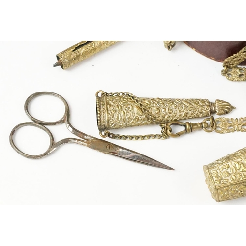 208 - An antique brass Chatelaine complete with pencil, pin cushion, scissors and thimble.