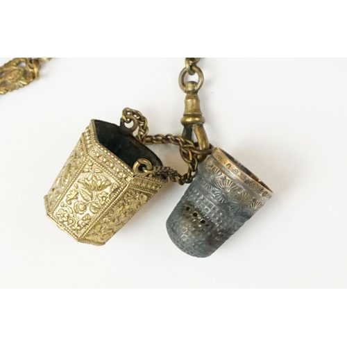 208 - An antique brass Chatelaine complete with pencil, pin cushion, scissors and thimble.