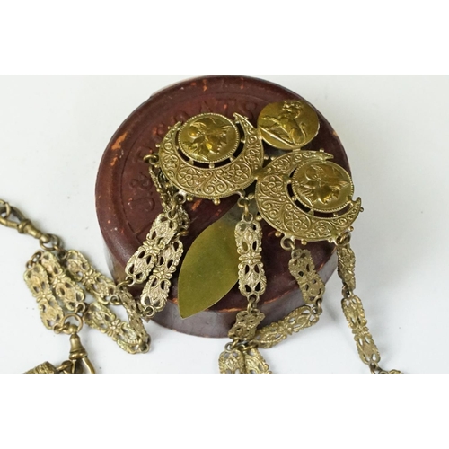 208 - An antique brass Chatelaine complete with pencil, pin cushion, scissors and thimble.
