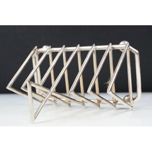 210 - Silver plated six section art deco style toast rack on bun feet