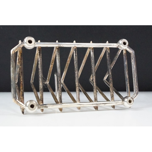 210 - Silver plated six section art deco style toast rack on bun feet