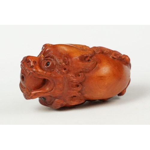 218 - Two carved oriental Netsuke in the form of mythical creatures.