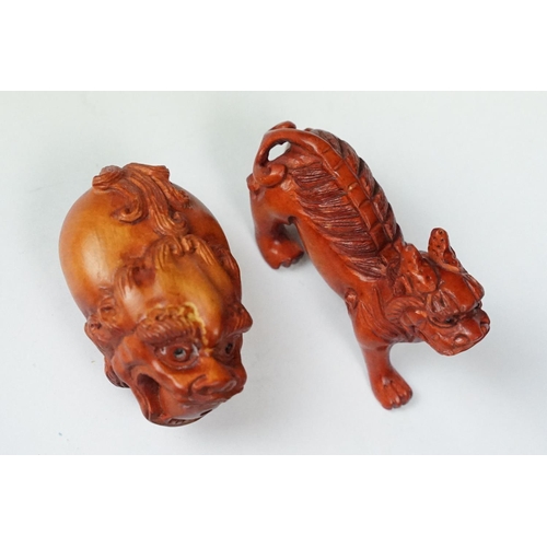 218 - Two carved oriental Netsuke in the form of mythical creatures.