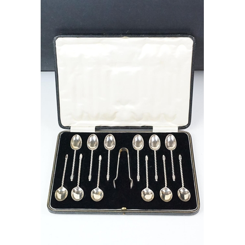234 - A cased set of twelve fully hallmarked sterling silver teaspoons together with sugar tongs contained... 