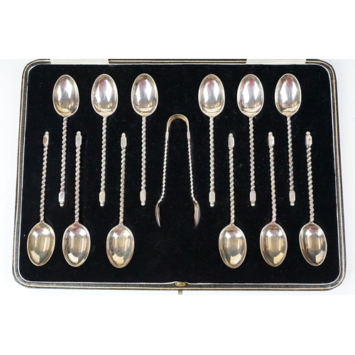 234 - A cased set of twelve fully hallmarked sterling silver teaspoons together with sugar tongs contained... 