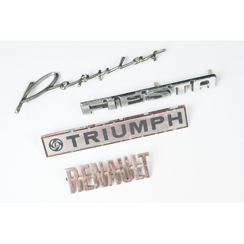 235 - Four vintage car badges including Triumph, Popular, Fiesta and Renault