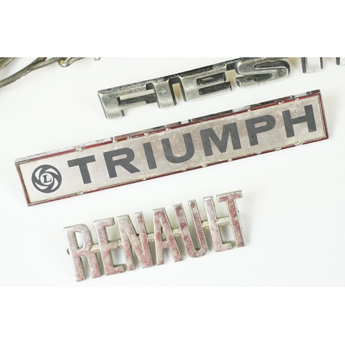 235 - Four vintage car badges including Triumph, Popular, Fiesta and Renault