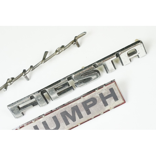 235 - Four vintage car badges including Triumph, Popular, Fiesta and Renault