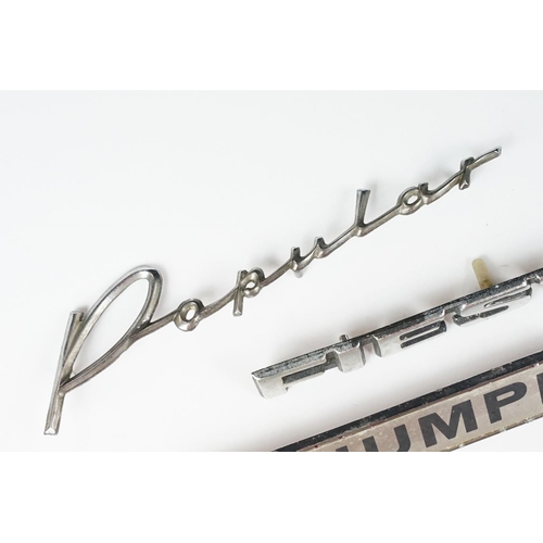 235 - Four vintage car badges including Triumph, Popular, Fiesta and Renault