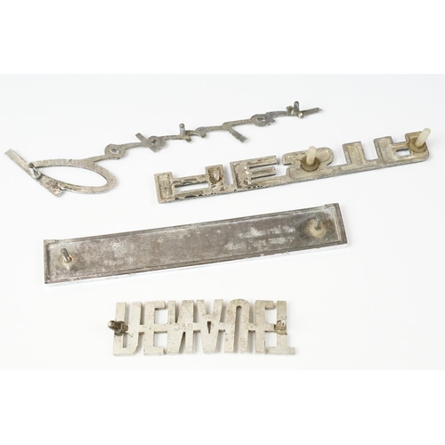 235 - Four vintage car badges including Triumph, Popular, Fiesta and Renault