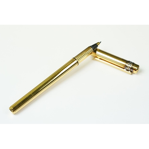 242 - A boxed Cartier leather purse together with a boxed Cartier pen, both with original display boxes.