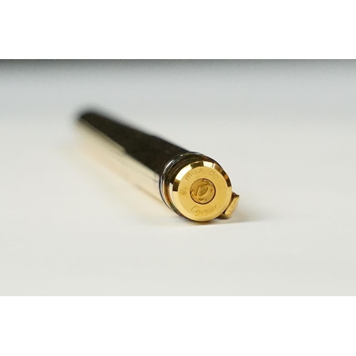 242 - A boxed Cartier leather purse together with a boxed Cartier pen, both with original display boxes.