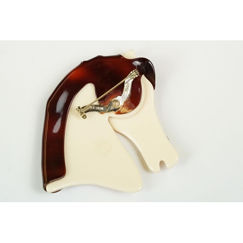 248 - A small group of costume jewellery to include a Lea Stein brooch in the form of a horse.