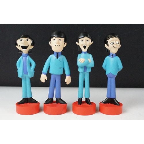342 - A set of four cast resin The Beatles ornamental figures together with a Rocky Toons Beatles print.