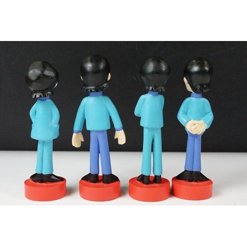 342 - A set of four cast resin The Beatles ornamental figures together with a Rocky Toons Beatles print.