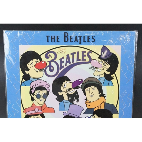342 - A set of four cast resin The Beatles ornamental figures together with a Rocky Toons Beatles print.