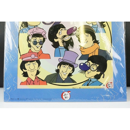 342 - A set of four cast resin The Beatles ornamental figures together with a Rocky Toons Beatles print.