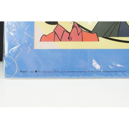 342 - A set of four cast resin The Beatles ornamental figures together with a Rocky Toons Beatles print.