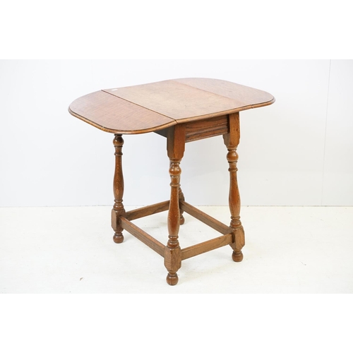593 - Small oak drop leaf table, with stretchered base, 61cm high x 69cm (extended) wide x 53cm deep