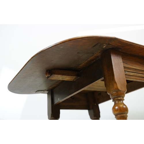 593 - Small oak drop leaf table, with stretchered base, 61cm high x 69cm (extended) wide x 53cm deep