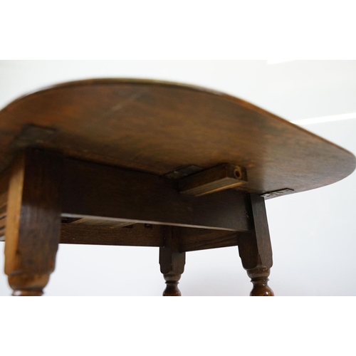 593 - Small oak drop leaf table, with stretchered base, 61cm high x 69cm (extended) wide x 53cm deep