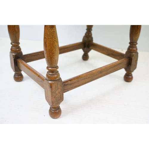 593 - Small oak drop leaf table, with stretchered base, 61cm high x 69cm (extended) wide x 53cm deep