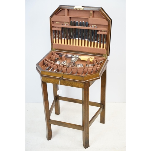 621 - Art Deco style walnut canteen of cutlery, on stretchered stand, containing silver plated flatware, 7... 