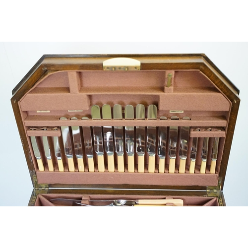 621 - Art Deco style walnut canteen of cutlery, on stretchered stand, containing silver plated flatware, 7... 