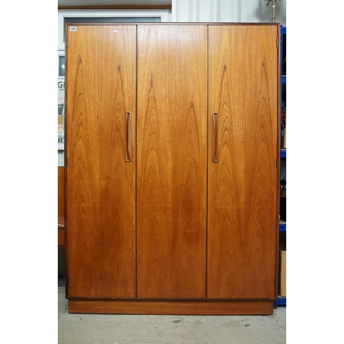 649 - G Plan three door wardrobe, two concertina doors and one further door, maker's label inside, hanging... 