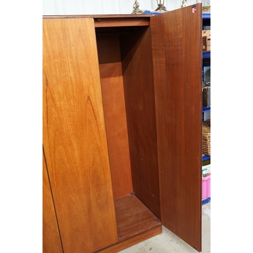 649 - G Plan three door wardrobe, two concertina doors and one further door, maker's label inside, hanging... 