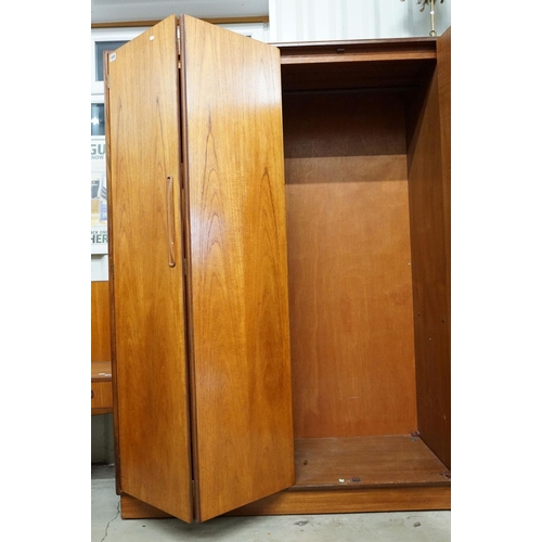 649 - G Plan three door wardrobe, two concertina doors and one further door, maker's label inside, hanging... 