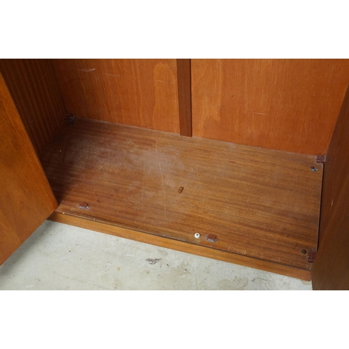 649 - G Plan three door wardrobe, two concertina doors and one further door, maker's label inside, hanging... 