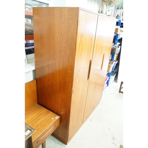 649 - G Plan three door wardrobe, two concertina doors and one further door, maker's label inside, hanging... 
