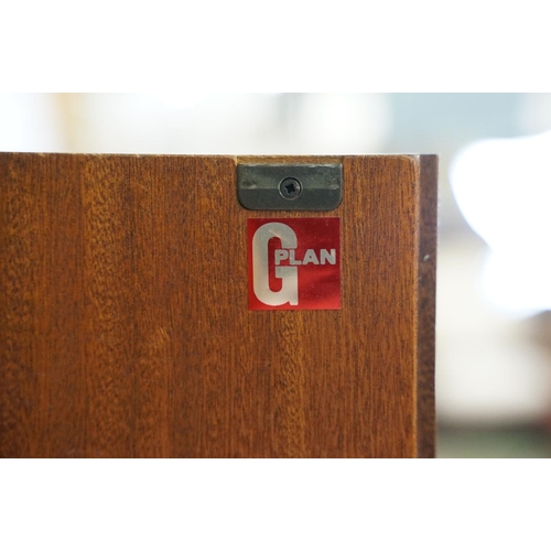 649 - G Plan three door wardrobe, two concertina doors and one further door, maker's label inside, hanging... 