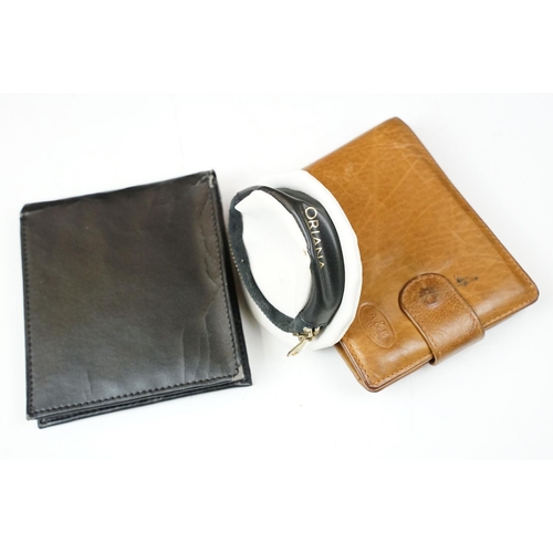 369 - A collection of over forty leather wallets and purses of various sizes and colours.