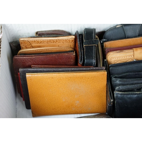 369 - A collection of over forty leather wallets and purses of various sizes and colours.