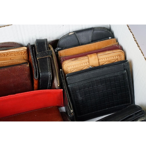 369 - A collection of over forty leather wallets and purses of various sizes and colours.