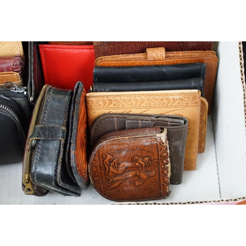 369 - A collection of over forty leather wallets and purses of various sizes and colours.