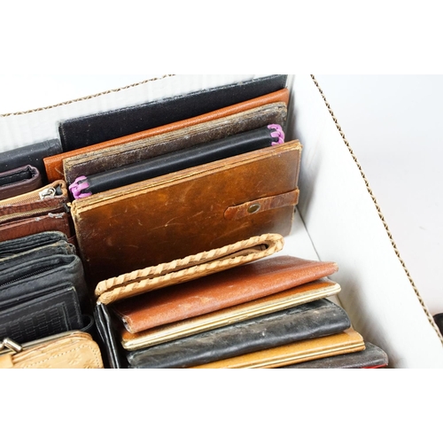 369 - A collection of over forty leather wallets and purses of various sizes and colours.