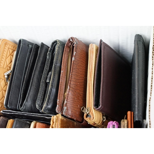 369 - A collection of over forty leather wallets and purses of various sizes and colours.