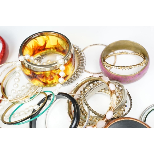 371 - A large collection of contemporary ladies cuff bangles.