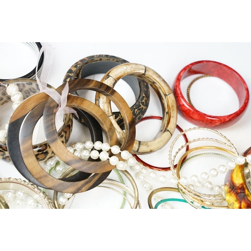 371 - A large collection of contemporary ladies cuff bangles.