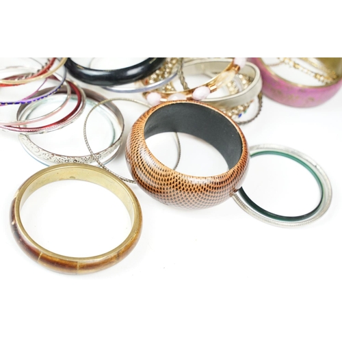 371 - A large collection of contemporary ladies cuff bangles.