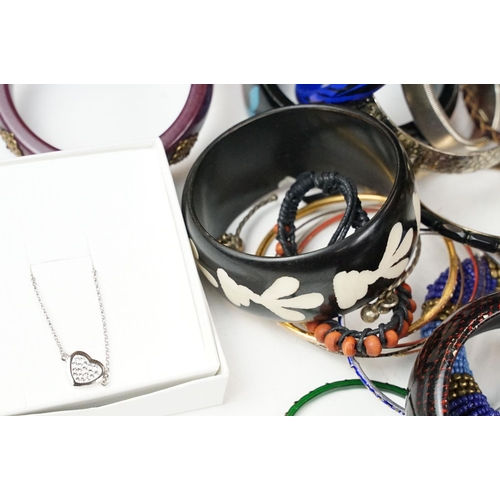 371 - A large collection of contemporary ladies cuff bangles.
