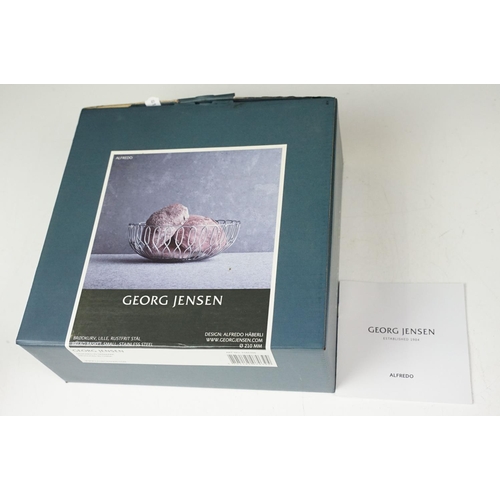 372 - A small Georg Jensen stainless steel bread basket within original box together with three commemorat... 