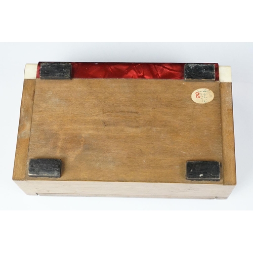 380 - Art Deco celluloid covered Art Deco jewellery box with silk lined interior. Measures 18cm wide.