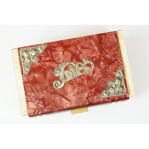 380 - Art Deco celluloid covered Art Deco jewellery box with silk lined interior. Measures 18cm wide.