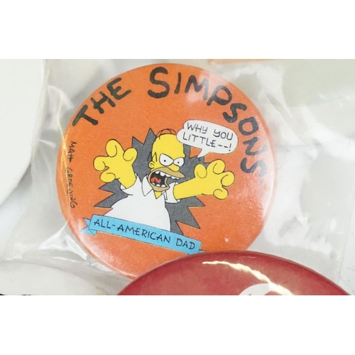 384 - A collection of vintage buttons badges and keyrings to include many advertising examples.