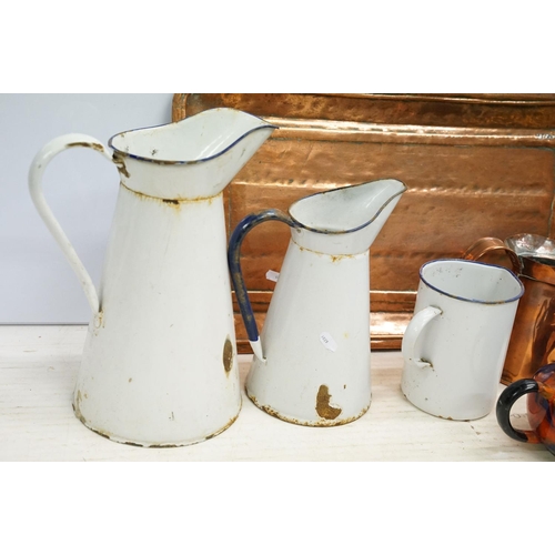 501 - Mixed metal ware to include enamel jugs, copper tray, brass vases, candlesticks, etc. (2 trays)