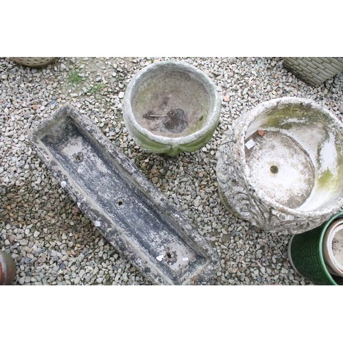 528 - Stone garden trough (approx 90cm long), together with two reconstituted stone footed planters